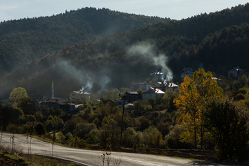 Fototapeta na wymiar smoke rising from a village in the morning in the Küre mountains of north central Turkey