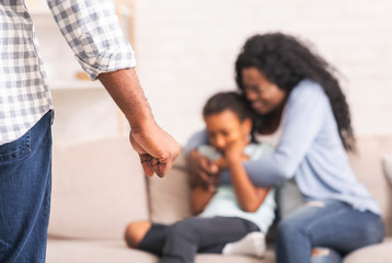Black mother and daughter suffering from domestic abuse from father