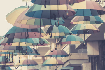Fototapeta na wymiar Road with umbrellas at Trikala in Greece in Sepia.