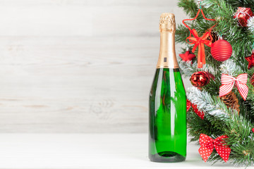 Christmas card with decorated fir tree and champagne
