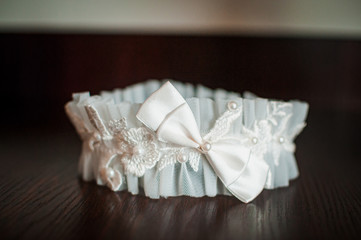 White color garter lying on the wooden table