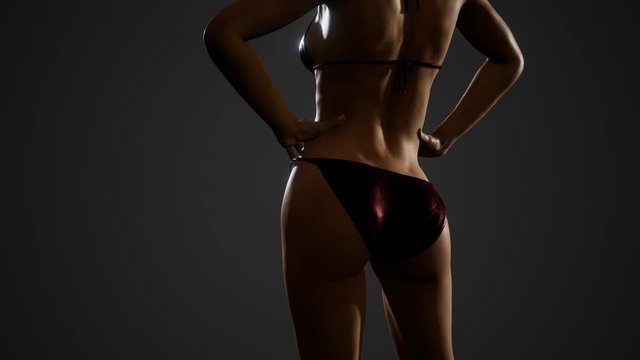 Fitness athletic woman in bikini posing