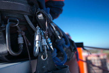 Rope access safety equipment Carabiners hard link clipping on hanging on side of technician harness...