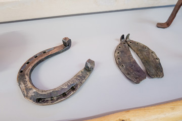 Cluj Napoca, Romania - 25 Oct, 2019: horse and cow shoe in an Exhibition in the Ethnographical Museum of Transylvania in Cluj Napoca, Romania.