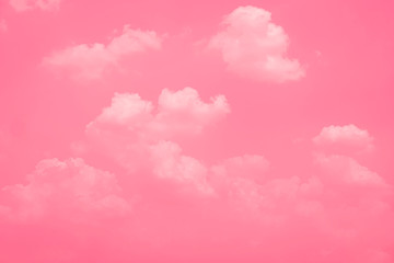 Fototapeta premium Pink sky background with white clouds.