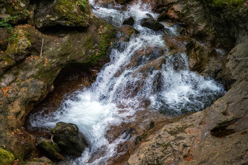 Fototapeta premium Scenic view of amazing water stream between rocks. Close up