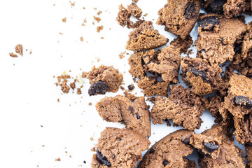 Cookies chocolate broken into pieces on white background.