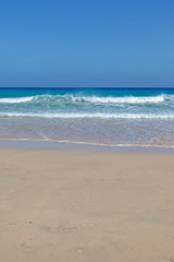 Fototapeta na wymiar Wonderful golden beach and turquoise sea. Vertical.