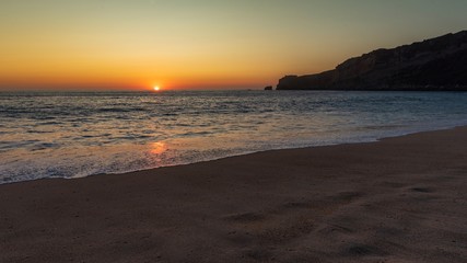 Sunset on the beach at Nazare, Portugal.