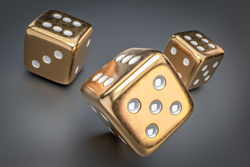 Set of golden dice with white dots isolated on black background