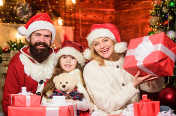 Obraz na płótnie Canvas Joyful people. Gifts from Santa. Lovely daughter with parents. Christmas traditions concept. Father Santa claus costume with mom and little kid celebrating christmas. Christmas is the time to please
