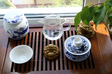 Chinese tea ceremony using tea utensils made of glass, clay and porcelain.