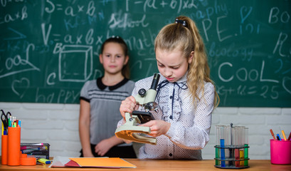 Girls study chemistry in school. Biology and chemistry lessons. Theory and practice. Observe...