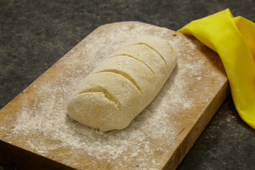 Bread dough on a wooden cutting board