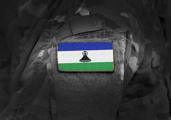 Flag of Lesotho on military uniform. Army, troops, soldiers. Collage.