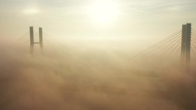 Aerial view. Siekierkowski, Bridge Spectacular Sunrise with low fog. View of the fog pattern around the Golden Gate Bridge. Warsaw. Poland. Drone Shot 4K.