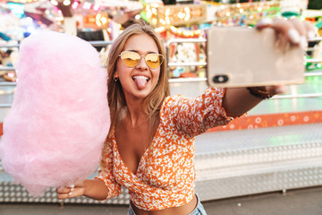 Happy cute woman walking outdoors in amusement park