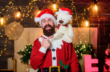 Fototapeta na wymiar Man bearded Santa claus play with soft toy teddy bear. Christmas charity. Celebrate new year. Winter fundraising ideas. Charity concept. Kindness and generosity. Charity help. Spread joy happiness