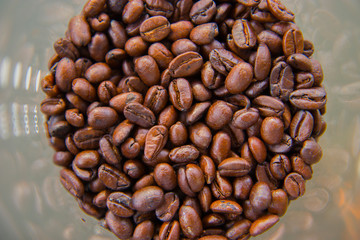 Fresh coffee beans into the glass, Food concept top view copy space.