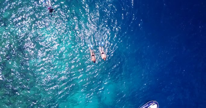 Young people going by ski jet for a leisurely swim and snorkel in tropical waters of Jamaica