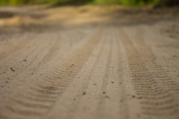 tires marks on sand, wheels on ground road