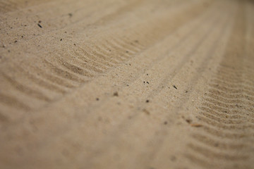Fototapeta na wymiar tires marks on sand, wheels on ground road