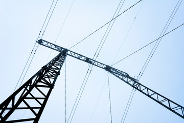 Fototapeta premium Electric support of high voltage power cables in heavy fog
