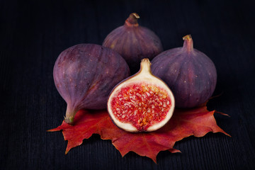 Fresh figs lying on a maple leaf