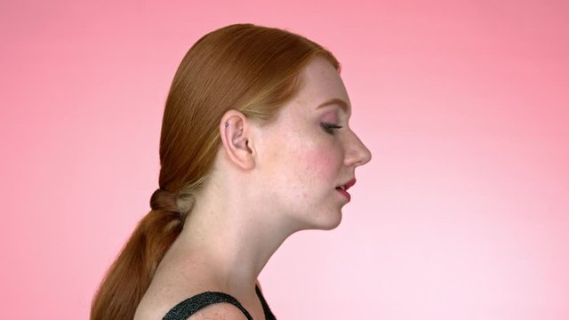 side view of serious girl in black dress, medium close up slow motion shot