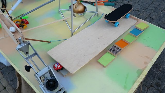 Rube Goldberg Machine. Skateboard launches a ball