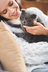 beautiful smiling woman with grey scottish fold cat