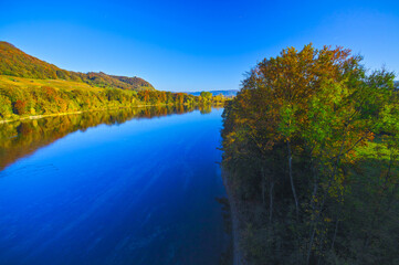 The river Rhine, only a few hundred meters young, after leaving Lake Constance. Autumn. Near the Swiss town Stein am Rhein. View from the car bridge to the west, the road leads to the Rhine Falls.