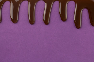Chocolate raining down on purple background