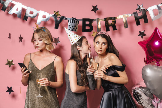 Image of young party girls holding smartphone while celebrating birthday