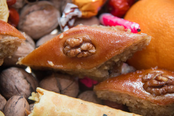 Baklava is in the background Xoncha . Isolated and macro shot of Novruz holiday cookie Paxlava . Baxlava .Baklava walnuts filling . Navruz Nowruz holiday, the spring New Year holiday.