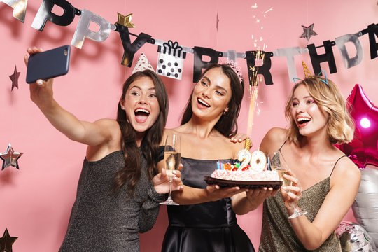 Image of party girls taking selfie photo and holding birthday cake