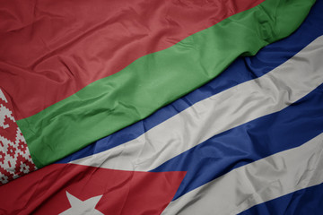 waving colorful flag of cuba and national flag of belarus.