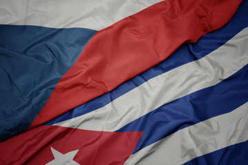 waving colorful flag of cuba and national flag of czech republic.
