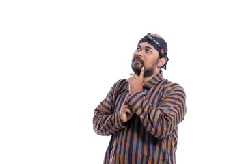 asian man with javanese traditional cloth lurik thinking and look up