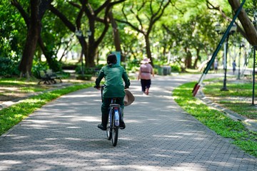 young woman riding a bicycle in park