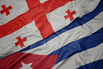 Fototapeta premium waving colorful flag of cuba and national flag of georgia.