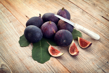 A few figs on an wooden background. Fresh healthy fruits.