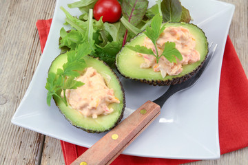 avocado with surimi and mayonnaise on a plate