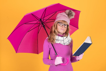 adult woman with umbrella and book warm clothes