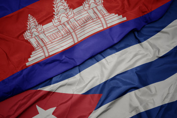 waving colorful flag of cuba and national flag of cambodia.