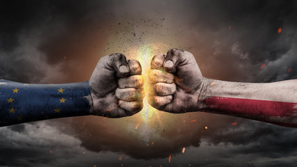 EU vs EU. Fists with flags. Battle EU with Poland on sky.