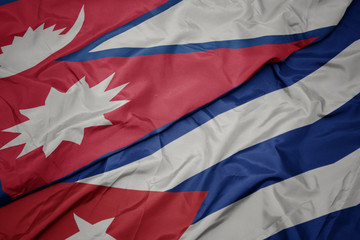 waving colorful flag of cuba and national flag of nepal.