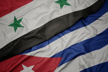 waving colorful flag of cuba and national flag of syria.