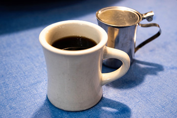 Coffee in White Mug On Blue Formica Table In A Diner In Bath Maine.