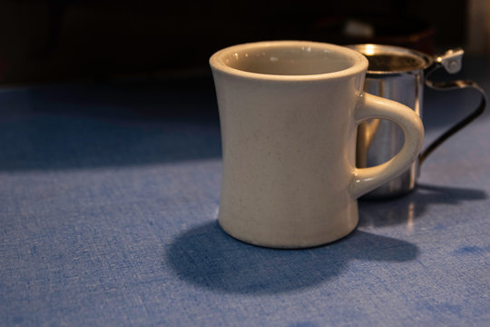 Coffee in White Mug On Blue Formica Table In A Diner In Bath Maine.